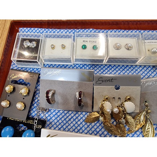 341 - A large quantity of various as new costume jewellery includes mostly earrings along with some bracel... 