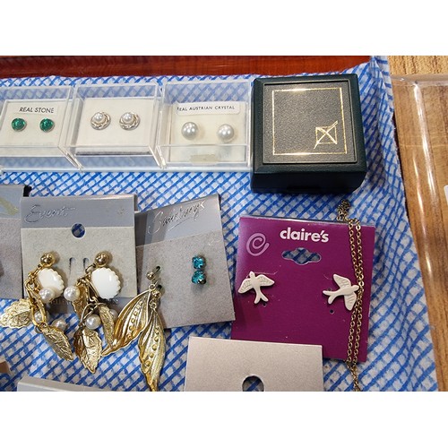 341 - A large quantity of various as new costume jewellery includes mostly earrings along with some bracel... 