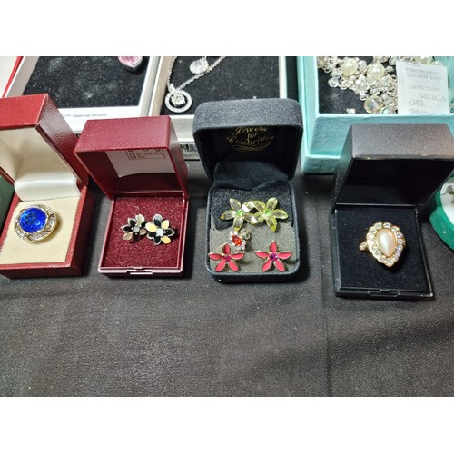 345 - A large quantity of boxed costume jewellery to include ornate dress rings, matching jewellery sets, ... 