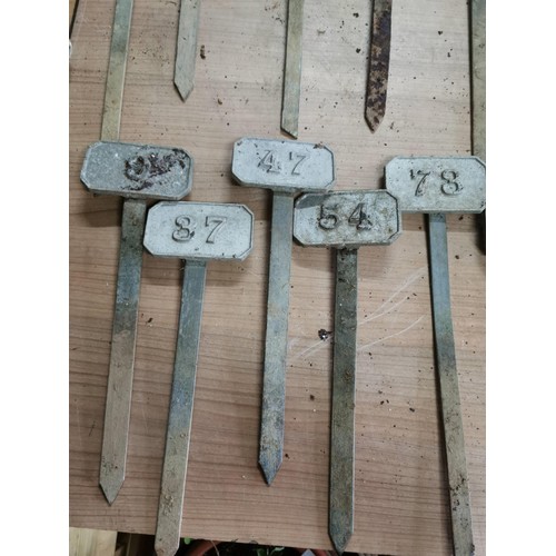 264 - Metal box containing a large quantity of numbered marking pegs for various uses all in good order he... 