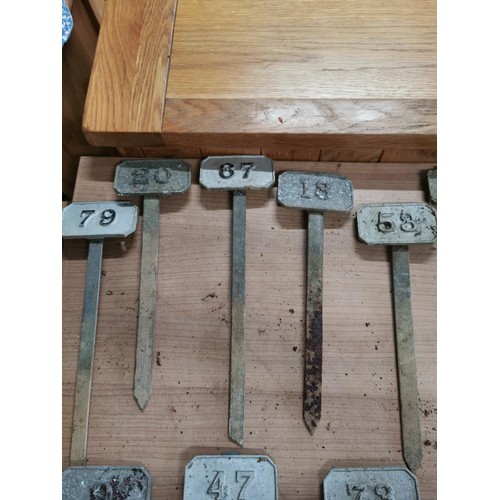 264 - Metal box containing a large quantity of numbered marking pegs for various uses all in good order he... 