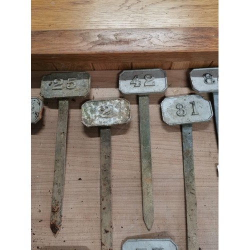 264 - Metal box containing a large quantity of numbered marking pegs for various uses all in good order he... 