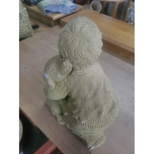 265 - Large garden stone ornament of a boy with his dog in good order stands at 41cm high, 31cm wide