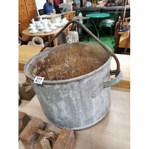 277 - Large galvanised bucket containing a quantity of 9x cast iron weights of various sizes, largest weig... 