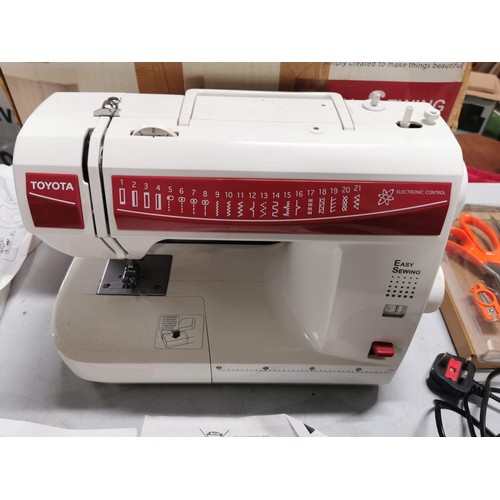 448 - Boxed electric Toyota sewing machine complete with accessories in good order