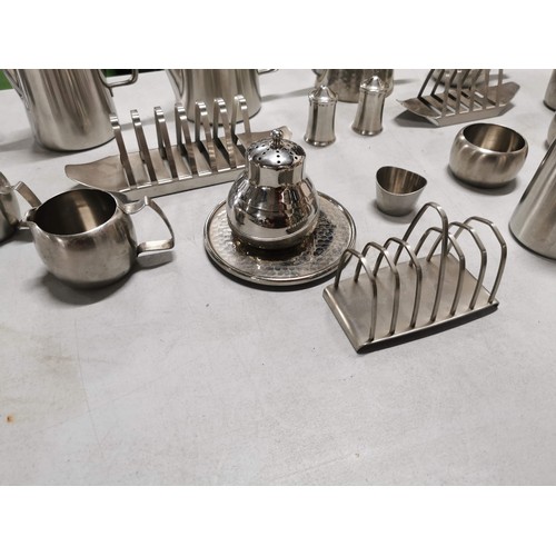 450 - Large quantity of stainless steal teapots, toast racks, jugs etc along with a stainless steel angle ... 