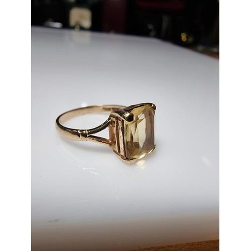 395 - A pretty 9ct yellow gold vintage dress ring inset with a large faceted citrine gemstone. Size of sto... 