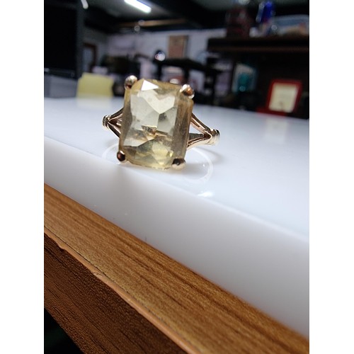 395 - A pretty 9ct yellow gold vintage dress ring inset with a large faceted citrine gemstone. Size of sto... 