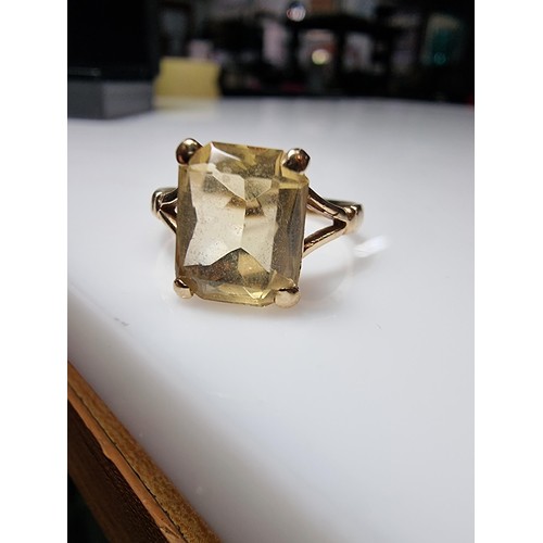 395 - A pretty 9ct yellow gold vintage dress ring inset with a large faceted citrine gemstone. Size of sto... 