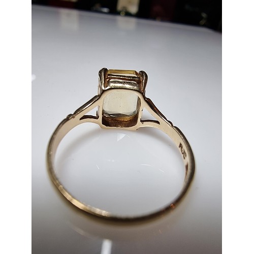 395 - A pretty 9ct yellow gold vintage dress ring inset with a large faceted citrine gemstone. Size of sto... 