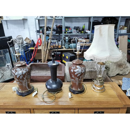 479 - Matching pair of ceramic brown table top lamps with floral design on wooden bases along with brass a... 