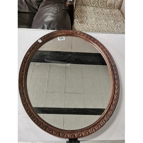 520 - Oranate oval framed mirror in good order height 54cm width 44cm