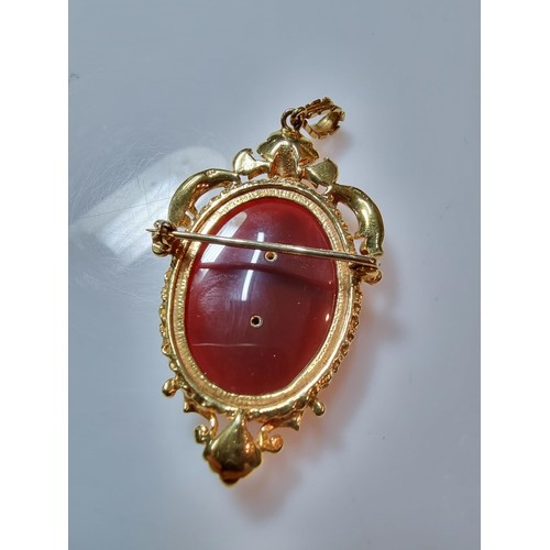 386 - A pretty ornate hallmarked 9ct yellow gold pendant/brooch inset with a large oval carnelian stone ov... 