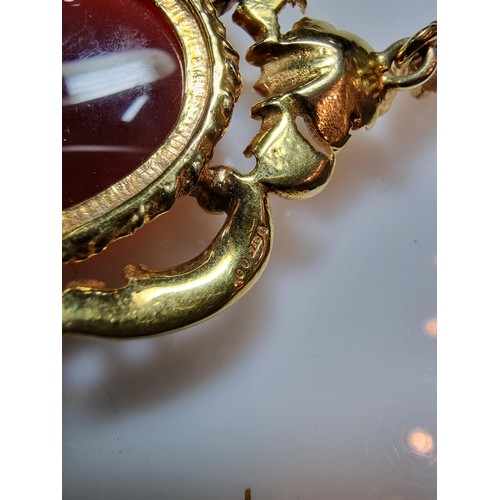 386 - A pretty ornate hallmarked 9ct yellow gold pendant/brooch inset with a large oval carnelian stone ov... 