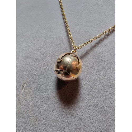 388 - A good quality 9ct gold and silver Victorian Masonic orb ball pendant, which opens up to reveal a cr... 