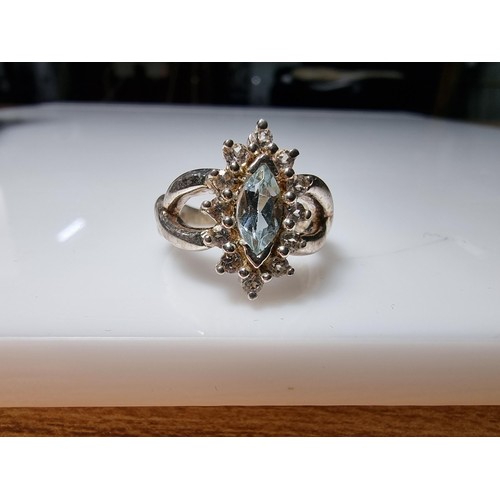 360 - A good quality ornate 925 silver dress ring inset with a blue topaz stone 1.25ct surrounded by small... 