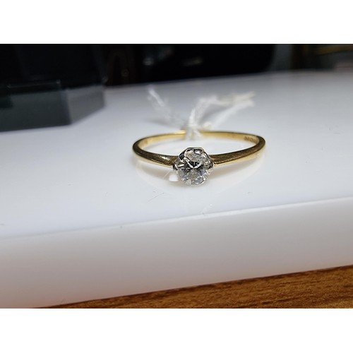 391 - A hallmarked 18ct yellow gold diamond solitaire ring inset with a 0.15ct diamond which is lively and... 