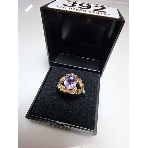 392 - A vintage 9ct hallmarked yellow gold ring with a bark effect, inset with a large faceted amethyst ge... 