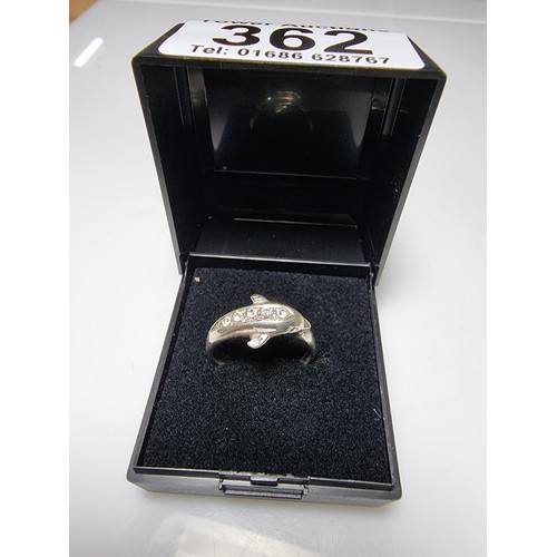 362 - A clean 925 silver dolphin ring inset with clear CZ stones, size O, boxed.