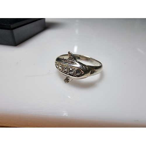 362 - A clean 925 silver dolphin ring inset with clear CZ stones, size O, boxed.