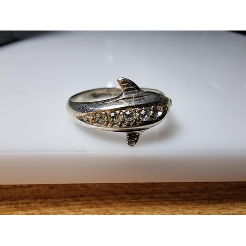 362 - A clean 925 silver dolphin ring inset with clear CZ stones, size O, boxed.