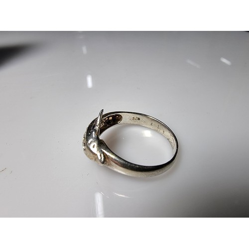 362 - A clean 925 silver dolphin ring inset with clear CZ stones, size O, boxed.