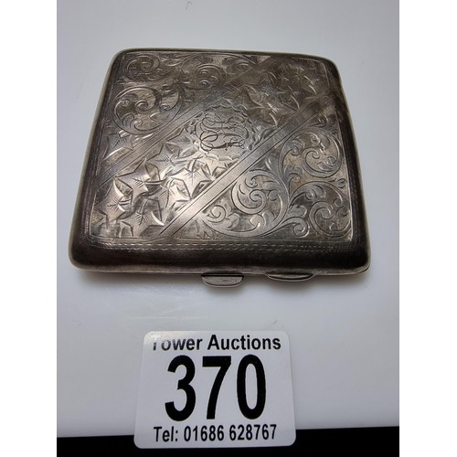 370 - A hallmarked silver cigarette case with an ornate engraved design and shaped for the hip. In good cl... 