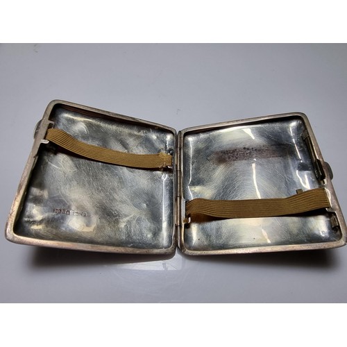 370 - A hallmarked silver cigarette case with an ornate engraved design and shaped for the hip. In good cl... 