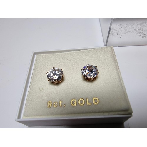 400 - A pair of 9ct yellow gold stud earrings inset with large CZ stones, in excellent clean condition and... 