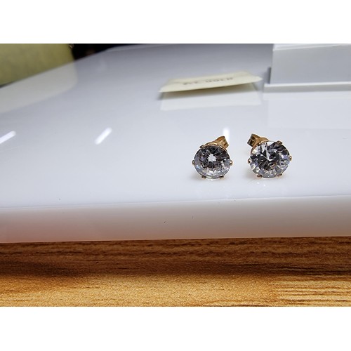 400 - A pair of 9ct yellow gold stud earrings inset with large CZ stones, in excellent clean condition and... 