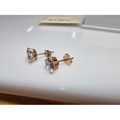 400 - A pair of 9ct yellow gold stud earrings inset with large CZ stones, in excellent clean condition and... 