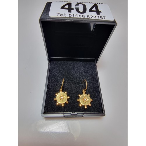 404 - A pair of pretty 9ct yellow gold drop earrings both inset with a small diamond, in as new condition ... 