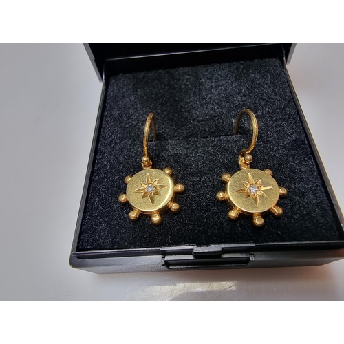 404 - A pair of pretty 9ct yellow gold drop earrings both inset with a small diamond, in as new condition ... 