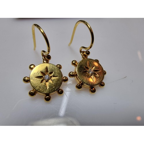 404 - A pair of pretty 9ct yellow gold drop earrings both inset with a small diamond, in as new condition ... 