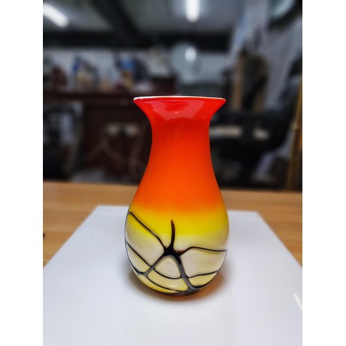 405 - A stunning art glass vase in sunset colours with an overlaid black web design to the base by an unkn... 