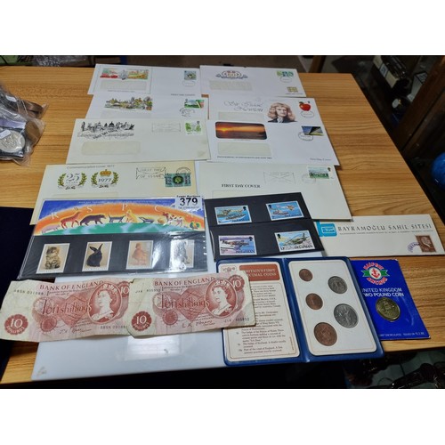 379 - A quantity of first day covers along with 2x English ten shilling notes, Britain's first decimal coi... 