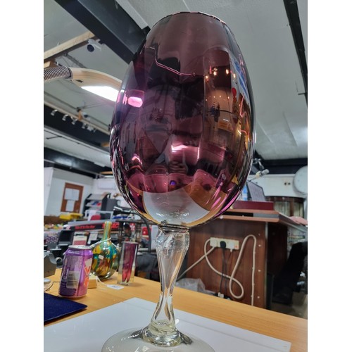 410 - A very large impressive retro wine glass formed vase in amethyst glass with a ribbed design in excel... 