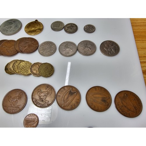 380 - A large quantity of various British and world coins to include a quantity of crowns, Irish coins, ol... 