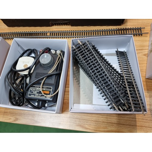 15 - A box containing a large quantity of OO gauge curved and straight track pieces, some with points alo... 