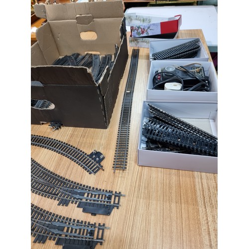 15 - A box containing a large quantity of OO gauge curved and straight track pieces, some with points alo... 