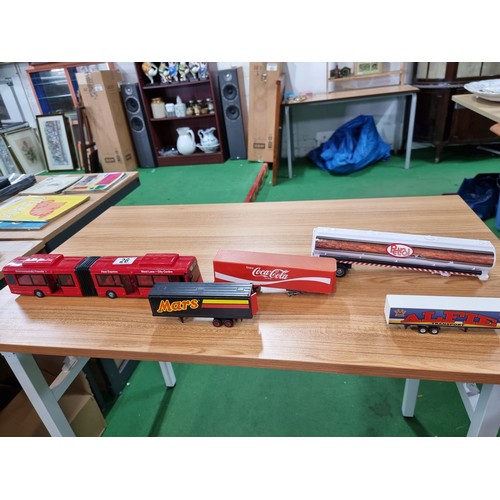 26 - A large quantity of various diecast cars and lorries including a quantity of truck trailers with adv... 