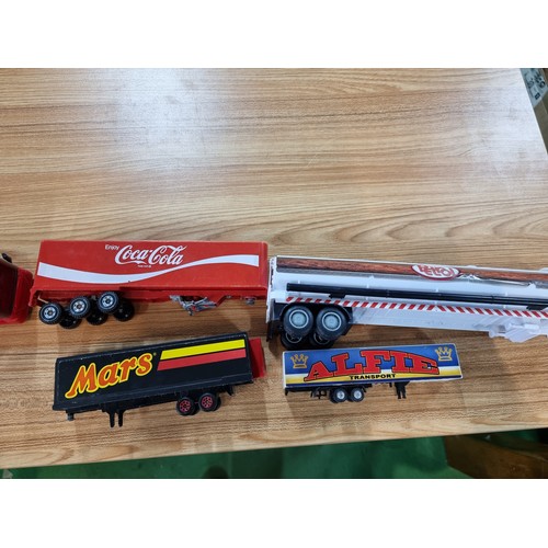 26 - A large quantity of various diecast cars and lorries including a quantity of truck trailers with adv... 