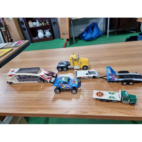 26 - A large quantity of various diecast cars and lorries including a quantity of truck trailers with adv... 