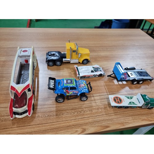 26 - A large quantity of various diecast cars and lorries including a quantity of truck trailers with adv... 