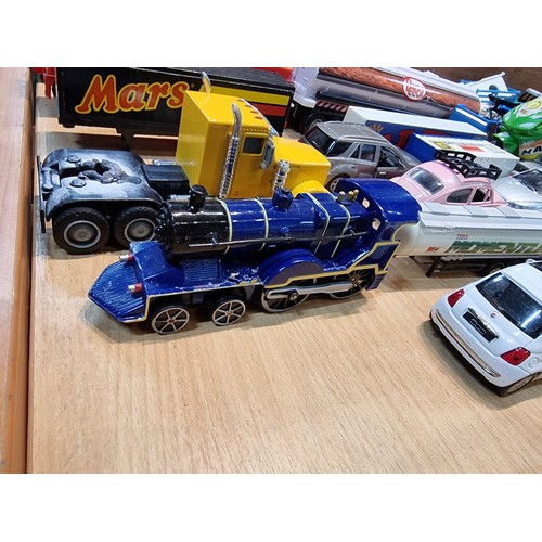 26 - A large quantity of various diecast cars and lorries including a quantity of truck trailers with adv... 