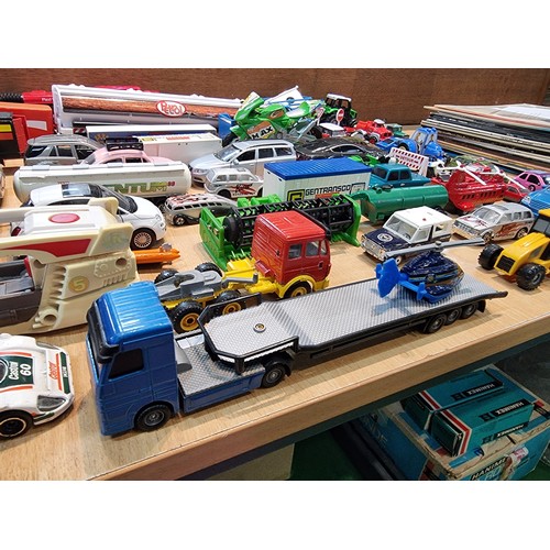 26 - A large quantity of various diecast cars and lorries including a quantity of truck trailers with adv... 