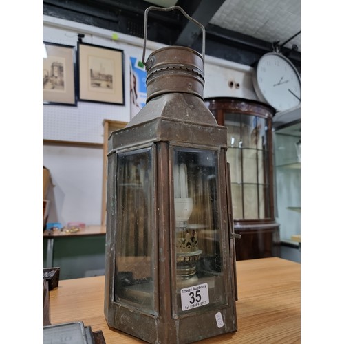 35 - A large wall hanging metal lantern with an electric bulb fitting along with a oak wall hanging barom... 