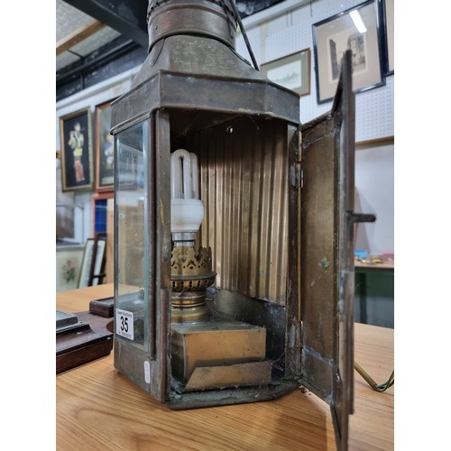 35 - A large wall hanging metal lantern with an electric bulb fitting along with a oak wall hanging barom... 