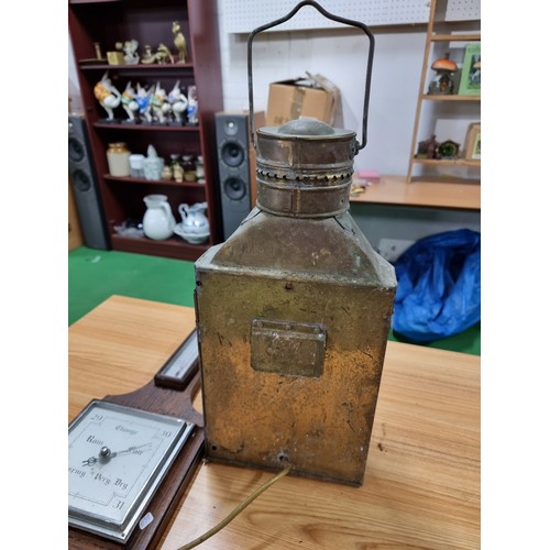 35 - A large wall hanging metal lantern with an electric bulb fitting along with a oak wall hanging barom... 