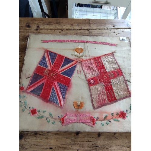 85 - A framed silk of the Cheshire regiment depicting 2 regimental flags and the Cheshire emblem to the t... 